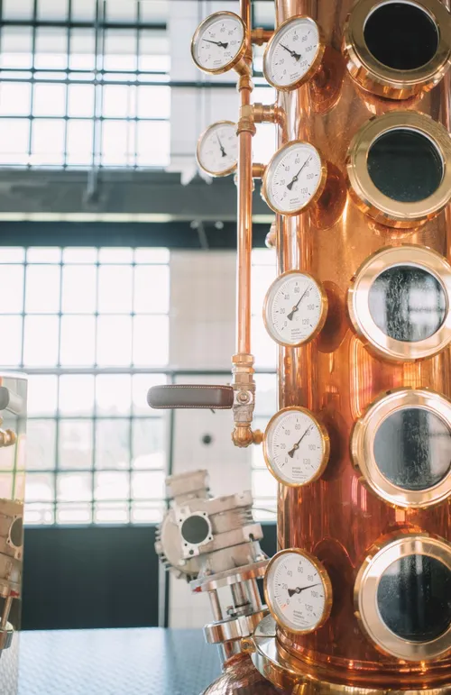 Copper column still with viewing windows and gauges
