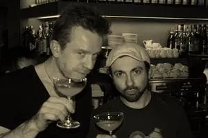 Two men tasting gin from coupe glasses