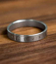 Silver ring lying on a wooden table