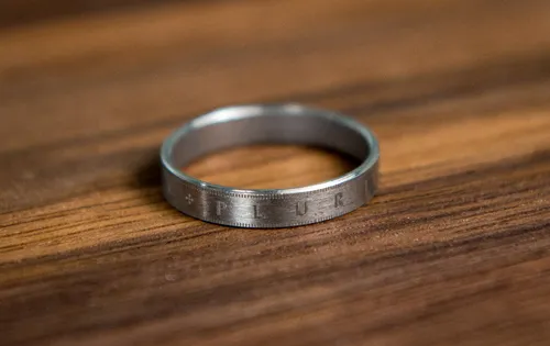 Silver ring lying on a wooden table