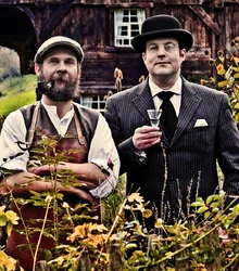 Alexander Stein and Christoph Keller holding glasses of gin outdoors