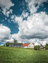 The Zum Wilden Affen distillery building in green meadows