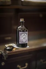 Monkey 47 bottle on a dark wooden counter