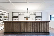 Tasting room with wooden bar and bottle shelves