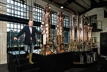 Monkey 47 founder in front of the copper stills