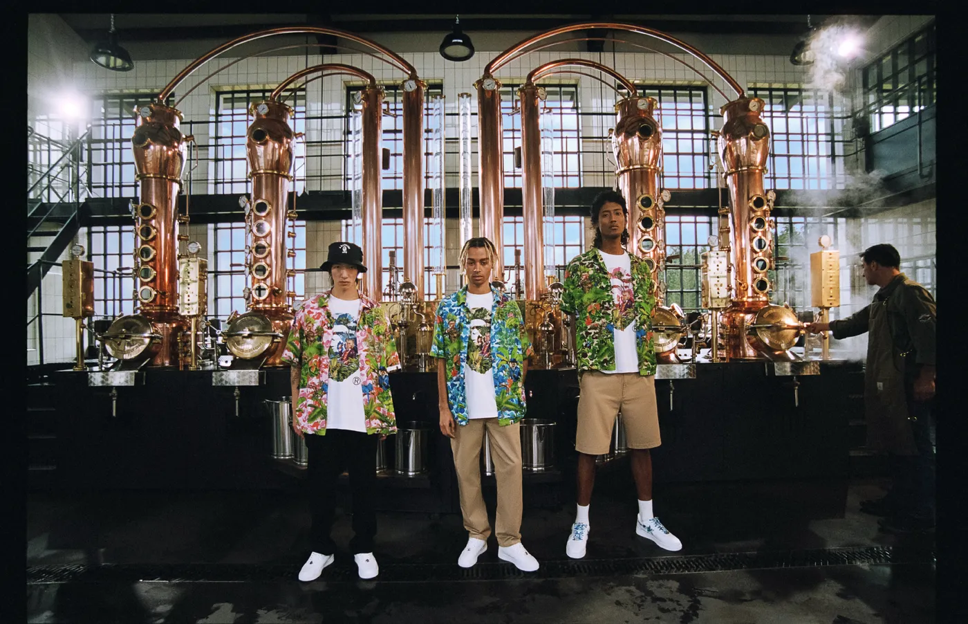 Guests in A Bathing Ape outfits in front of the copper stills at the Monkey 47 distillery