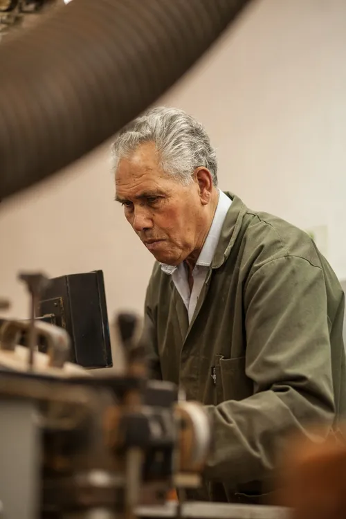 Worker operating a machine in a cork factory