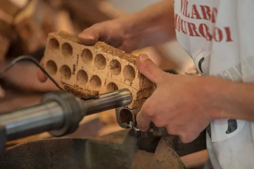 Worker holding a cork strip with corks punched out