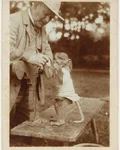 Vintage sepia photo of a man with a monkey