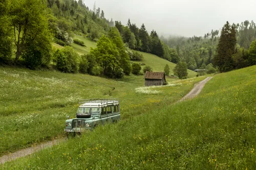 Land Rover driving through a green Black Forest valley
