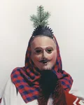 Butzenzuttel of Hirrlingen carnival costume with carved wooden mask and red checked hood