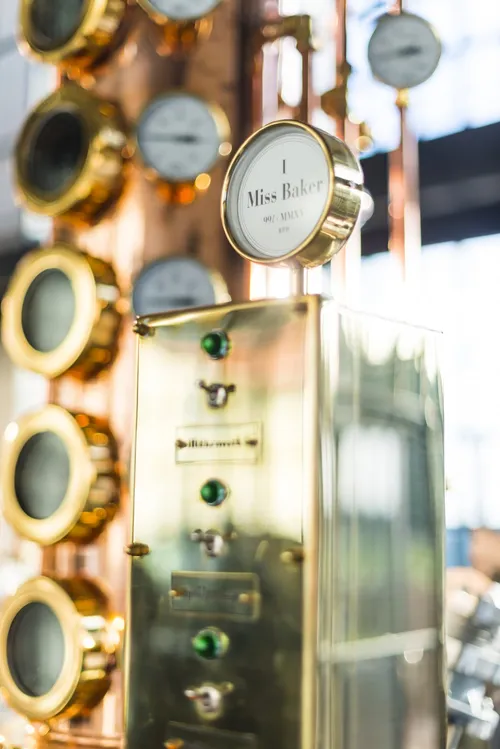 Copper still with gauges and a nameplate in the Monkey 47 distillery