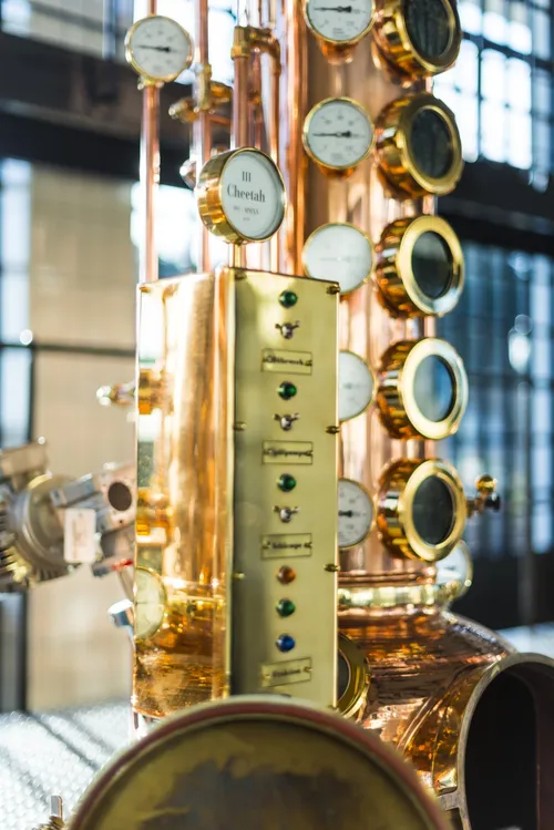 Copper stills with sight glasses in the Monkey 47 distillery
