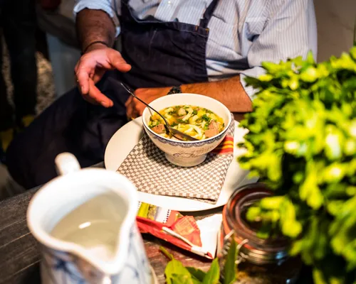 Bowl of Swabian stew with a carafe on the table