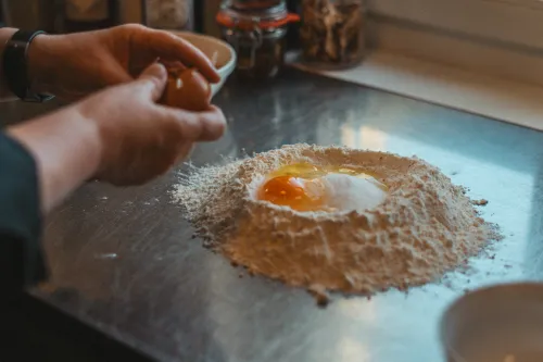 Egg in a well of flour for hazelnut braid dough