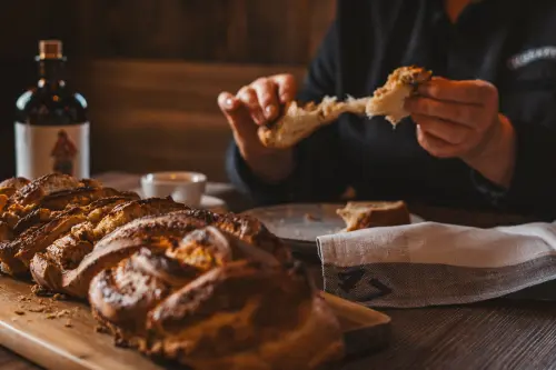 Hazelnut braid being torn apart, with a Monkey 47 bottle in the background