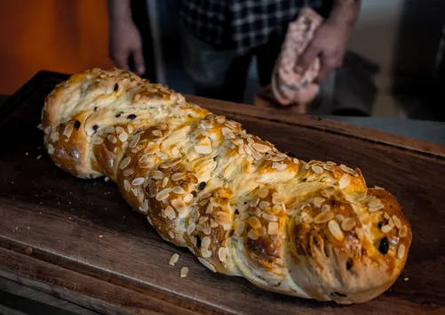 Golden baked Swabian yeast plait on a wooden board