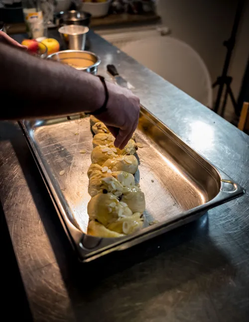 Braided yeast plait in a steel baking tray