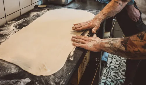Rolling out pasta dough for Maultaschen