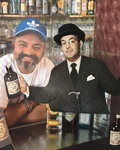 Two men posing at the bar with Monkey 47 bottles