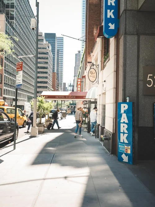 Sunny New York street with a parking sign