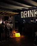 Illuminated "Drink" sign at the entrance of Nautoscopio Arte