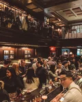 Crowded wood-panelled bar at NoMad New York