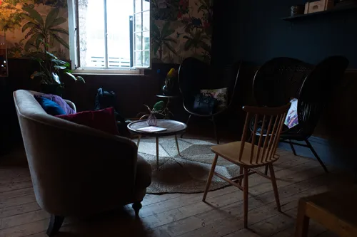 Cosy lounge with armchairs in a dimly lit room