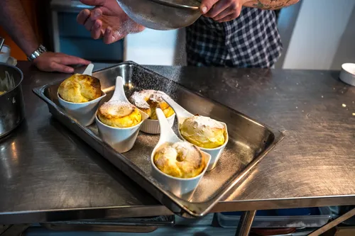 Ceramic spoons of custard dessert on a tray