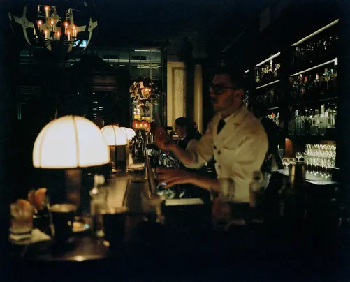 Bartender behind the bar at Scarfes Bar, Rosewood London