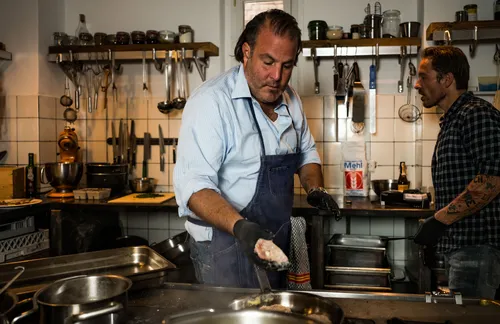Two chefs cooking in a restaurant kitchen