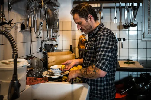 Chef plating food at the kitchen counter