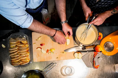 Layering bread slices in a baking dish with custard