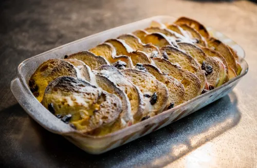 Baked bread pudding dusted with icing sugar