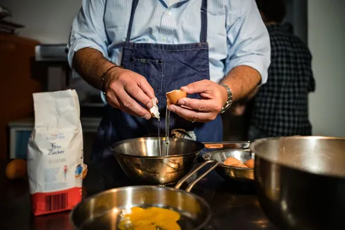 Chef cracking eggs into a bowl