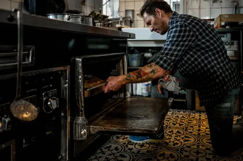 Chef putting a dish into the oven