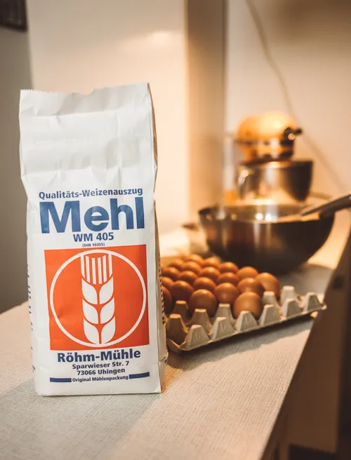 Bag of flour and eggs on a kitchen counter