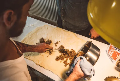 Spreading nut filling onto rolled-out dough