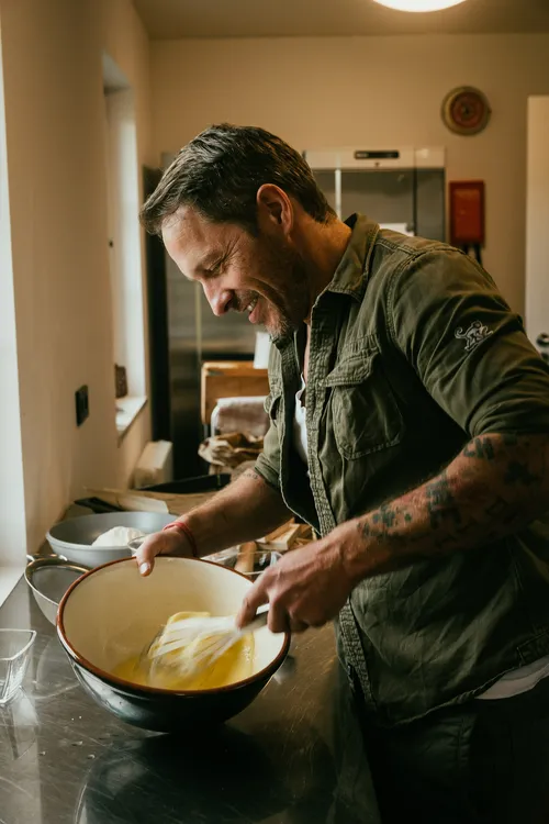 Baker whisking eggs and sugar for Springerle