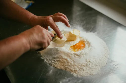 Mixing egg and flour for the plum cake dough