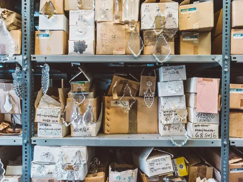 Shelves stacked with boxes of glass parts
