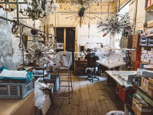 Workshop full of chandeliers and glass parts