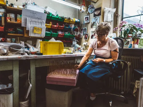 Woman working at a desk in the chandelier workshop