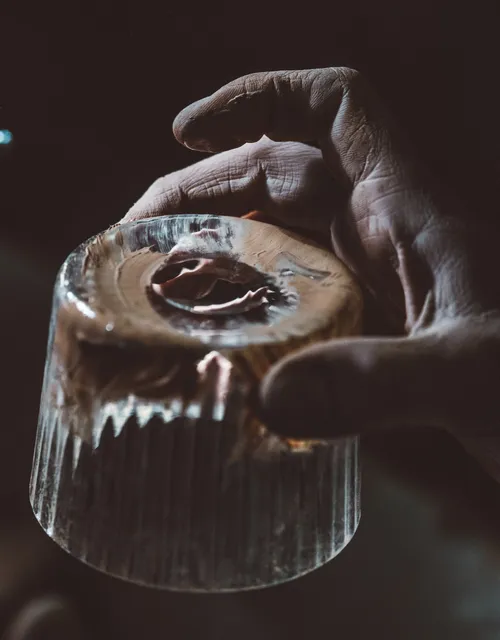 Hand holding a cut crystal glass