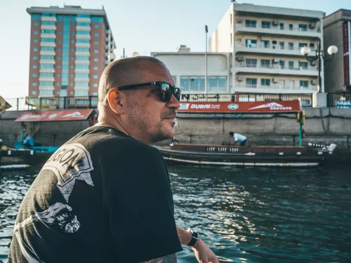 Man in sunglasses on a boat on Dubai Creek