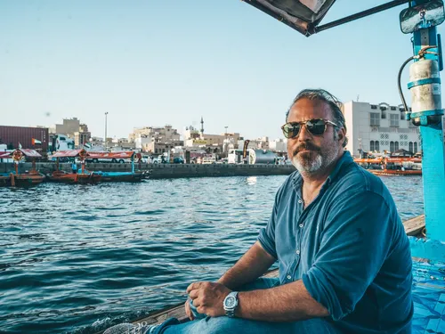 Man sitting on an abra boat on Dubai Creek