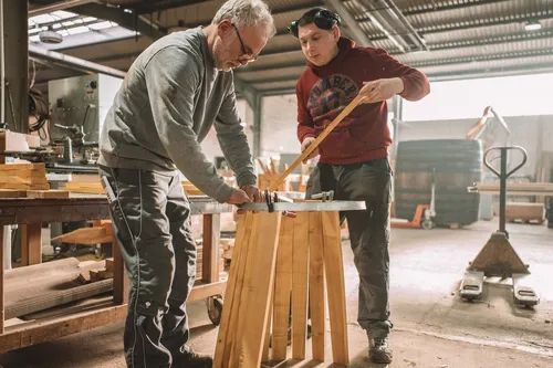 Two coopers arranging staves into a barrel shape