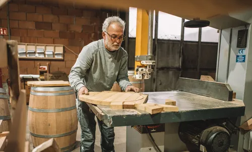 Cooper preparing oak wood at a workbench