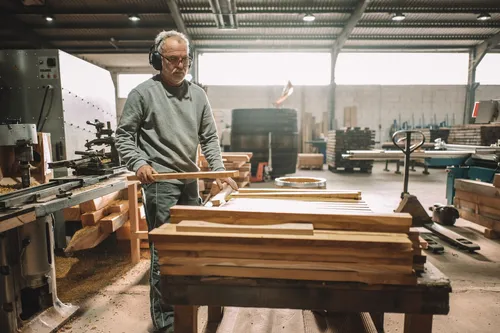 Cooper stacking oak staves in the workshop