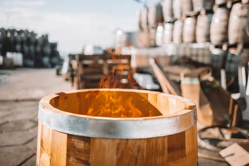Toasting the inside of an oak barrel over fire